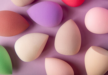 Beauty blender. Colorful beauty sponges on a lilac background. Cosmetic tool for applying foundation, concealer. Place for text. Place to copy.