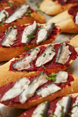 Herring fillet. Sandwich with salted herring and beetroot pate on the toasts on white plate. Scandinavian cuisine. close-up