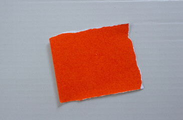 Ripped paper on grey background. Torn paper piece with copy space for text.