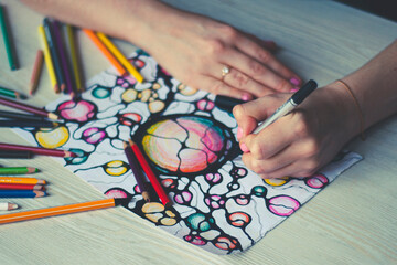 A woman draws neurographics, close-up. Abstract neurographic drawing with a marker, colored...