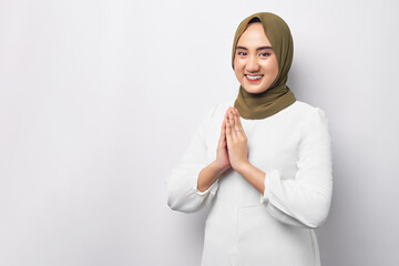 Fototapeta premium Beautiful smiling friendly young Arabian Asian Muslim woman wearing hijab standing gesturing Eid Mubarak greeting isolated on white background. People religious lifestyle concept