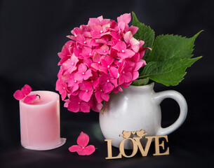 hydrangea bouquet with pink candles on black background