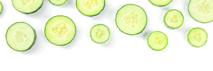 Fresh cucumber slices on a white background panorama with copy space, overhead flat lay shot....