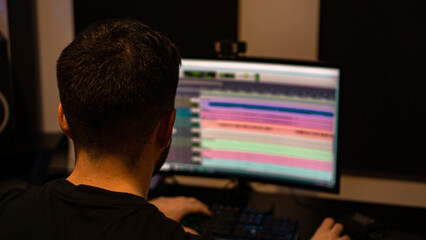 person mixing music on pc