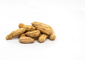 Close up stream peanuts, smalll heap of peanuts with shell, side view, selected focus, image on white background.