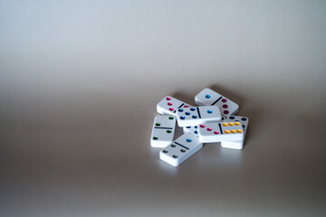 Fototapeta na wymiar multi-colored dominoes on a gray-beige background
