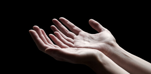 The outstretched hands of a praying man