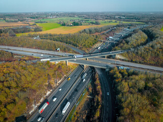 Vehicles Driving Along a Busy Motorway Interchange in the UK Aerial View