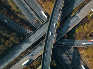 Fototapeta na wymiar Vehicles Driving Along a Busy Motorway Interchange in the UK Aerial View