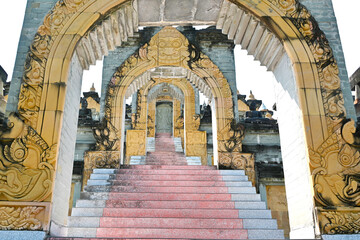 Archways and stairs lead up to a huge complex of sandstone stupas at the temple in Thailand