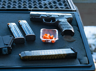 Hand gun case with ammo magazines and ear protection