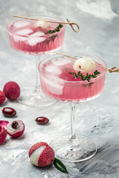 Delicious lychee cocktail in glass and fresh fruits, vertical image. top view. place for text