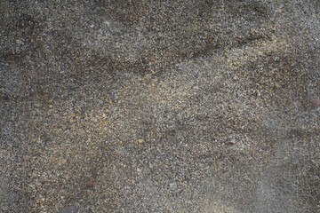 Small sea pebbles background, sea backdrop. Texture of the sea beach.