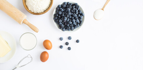 Top view of ingredients for making blueberry pie or cake on the white background. Copy space.