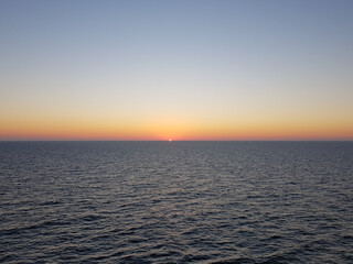 Sunset at Baltic Sea with a small sun in the horizon