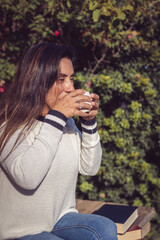 Moment of Tranquility: Latina Woman Drinking Coffee in the Garden