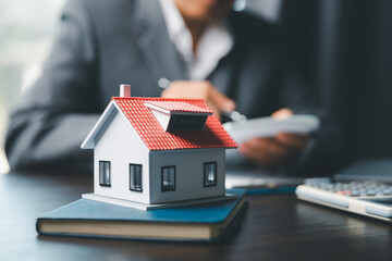 Business woman or lawyer accountant working financial investment on office. insurance protective hand over house for protection and care, Concept of home and real estate Property insurance.