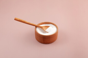 Stevioside powder, glycoside derived from the stevia plant, natural sweetener. Extract found in the leaves of Stevia rebaudiana. Food additive E960. Sugar substitute in wooden bowl