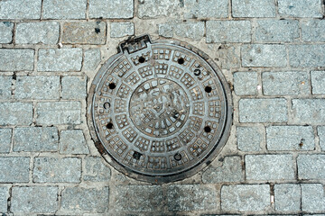 Cast-iron road hatch on stone road in Istanbul