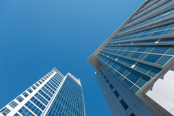 Fototapeta na wymiar Looking up at tall buildings in Charlotte, North Carolina with perfect Carolina blue sky.