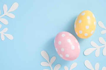 Happy Easter Colorful Easter eggs flat lay on blue background. Stylish tender spring template with space for text. Greeting card or banner