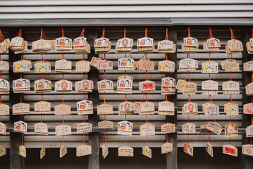 Wooden card is hanging on a rope outside Kushida Shrine.