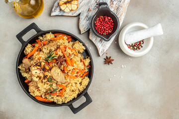 Uzbek pilaf in cast-iron pan. banner, menu, recipe place for text, top view