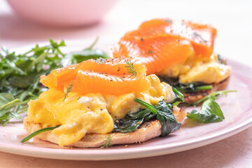Scrambled eggs with smoked salmon and avocado on a whole wheat toast