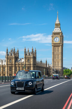 Black cab on Westminster bridge, Big Ben in the background, in London, UK