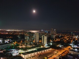 Fototapeta na wymiar beautiful photo of the night city with the moon. view from above. night sea
