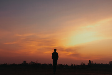 Silhouette man standing in the sunset.