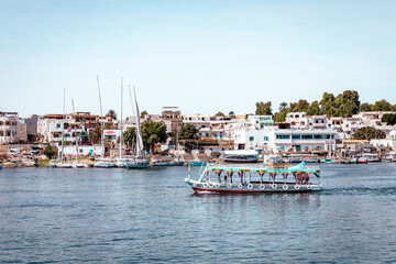 Felucca Sailing on the Nile River in Aswan. Popular Tourist Sailboat in the Nile. Aswan, Egypt. Africa.