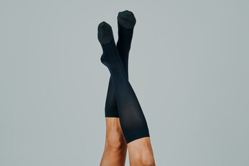 man upside down wearing compression socks