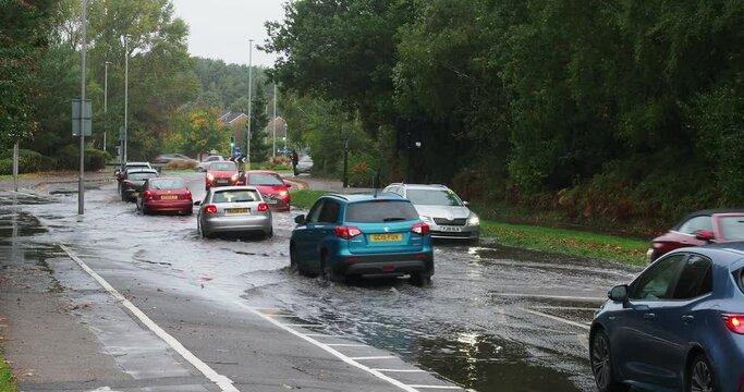 A short full HD video clip of cars negotiating a section of flooded road in the UK