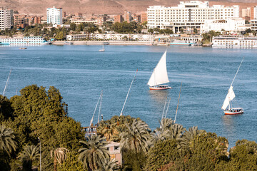 Felucca Sailing on the Nile River in Aswan. Popular Tourist Sailboat in the Nile. Aswan, Egypt....