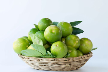 Green lemon in rattan basket for sell at market and supermarket.