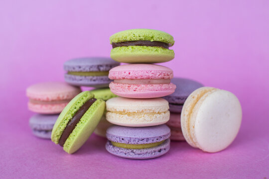 colorful macaroons on pink background
