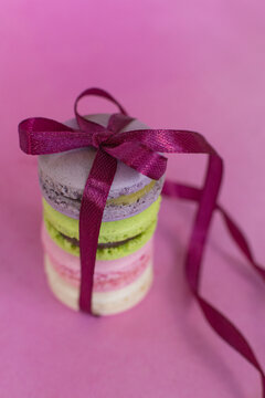 colorful macaroons on pink background