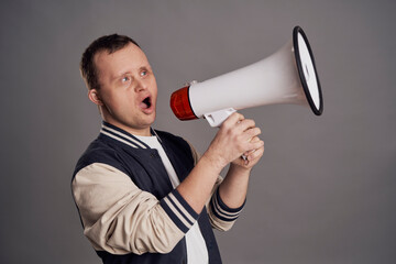 Man with down syndrome speaking through a white megaphone
