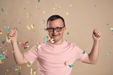 Man with down syndrome celebrating with confetti