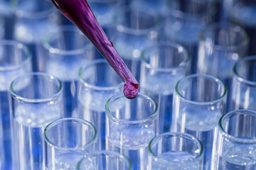 Pipette dropping fluid into test tube