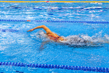 woman athlete swimmer freestyle swim in swimming competition