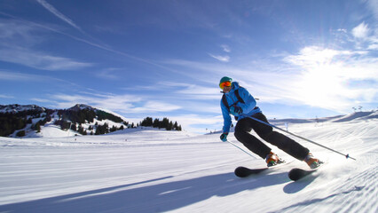 professional skier skiing on slopes in the Swiss alps towards the camera