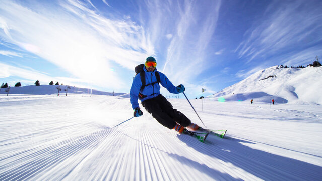 professional skier skiing on slopes in the Swiss alps towards the camera