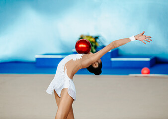 girl gymnast performance with ball in rhythmic gymnastics