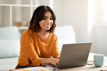 Remote Work Concept. Happy Young Arab Woman Working On Laptop At Home