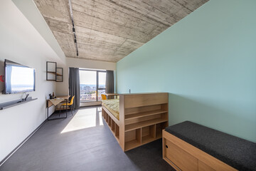 Simple student-style dorm bedroom. Hostel dormitory room. Campus