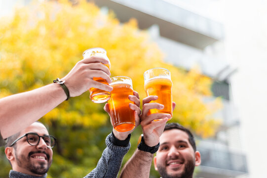 Toast Between Friends Outside The Bar, Smiling And Happy Celebrating.