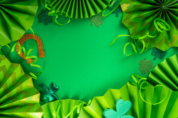 St Patrick flatlay background with shamrock clover leaves, leprechaun hat decor, golden coin, party...