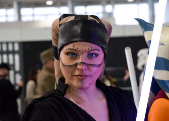 Warrior woman with purple sword in cosplay event